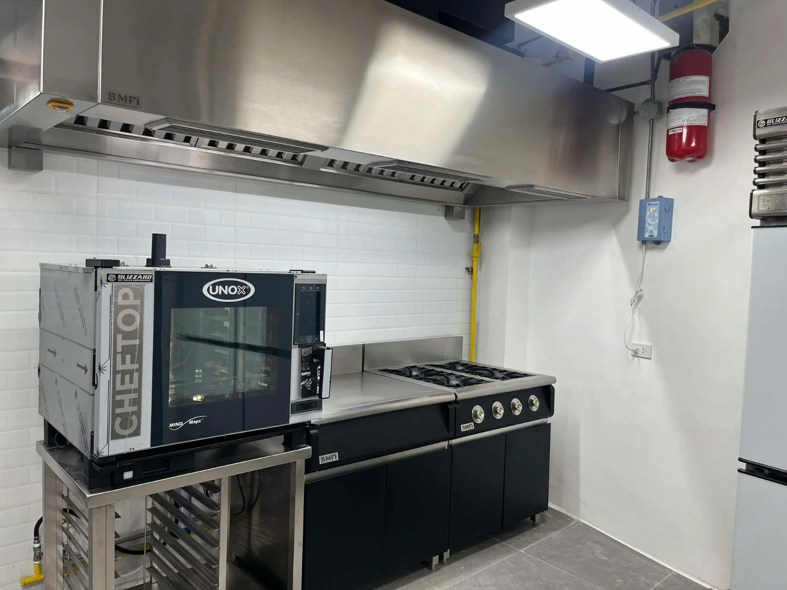 A kitchen with a fire suppression system applied.