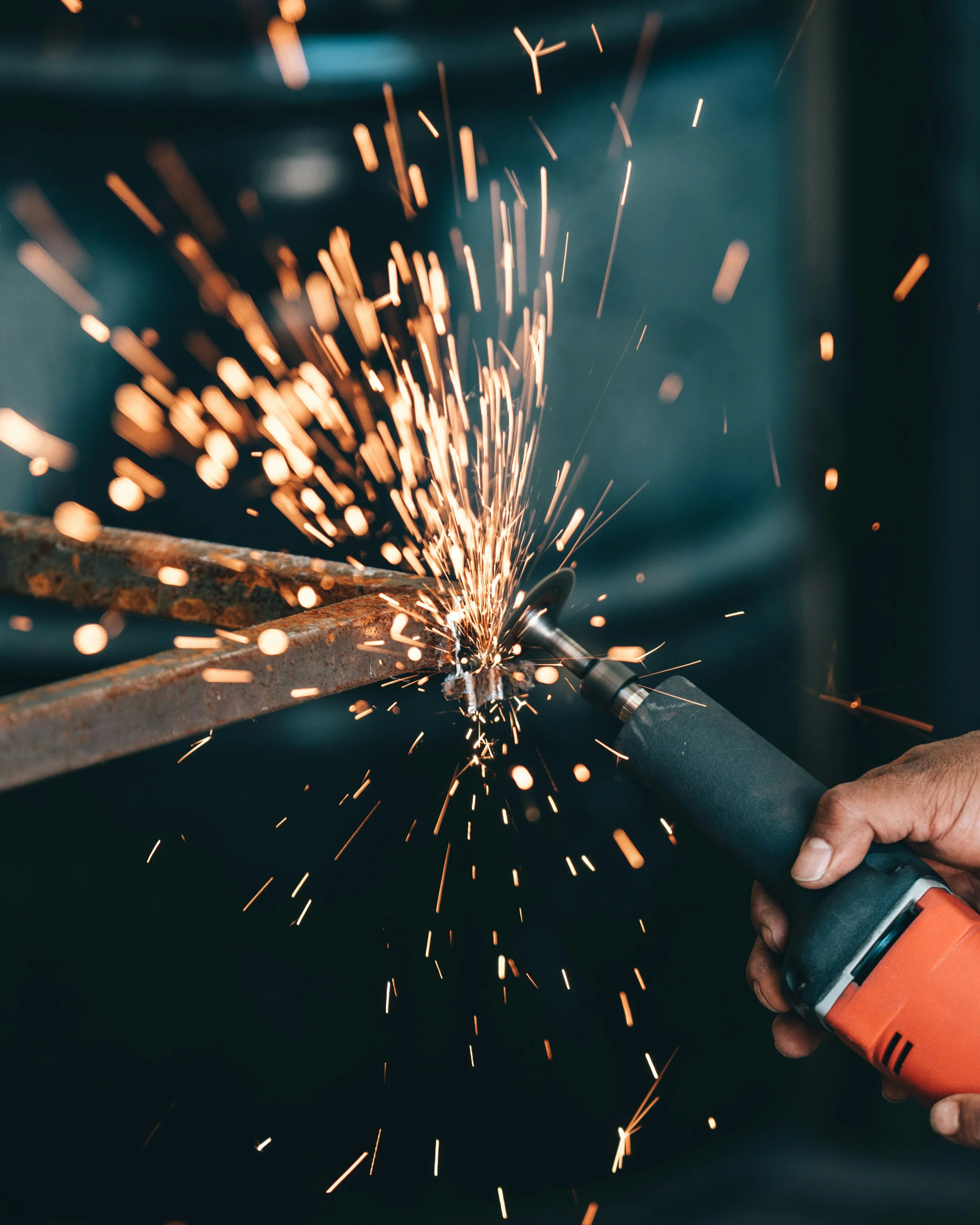 A person welding a stainless metal
